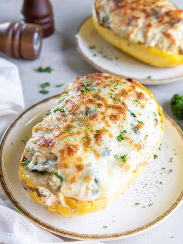 Two plates each holding a serving of spaghetti squash with chicken.