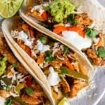 3 Chicken Fajitas on a white plate.