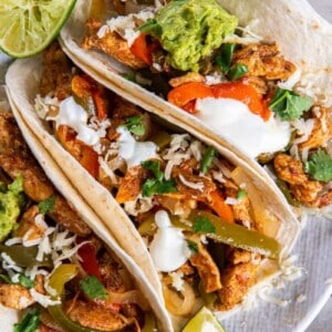 3 Chicken Fajitas on a white plate.