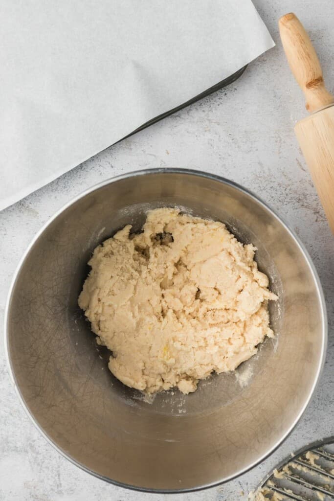 Combing wet and dry ingredients for cookie dough in a mixing bowl.