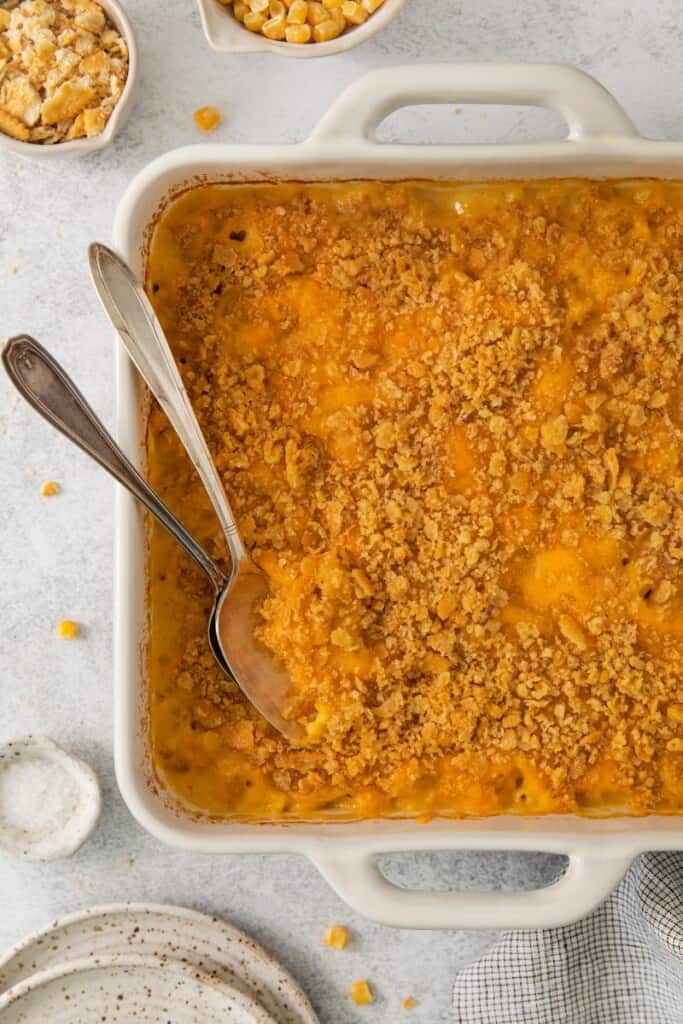 Baked corn macaroni casserole in a square casserole baking dish.