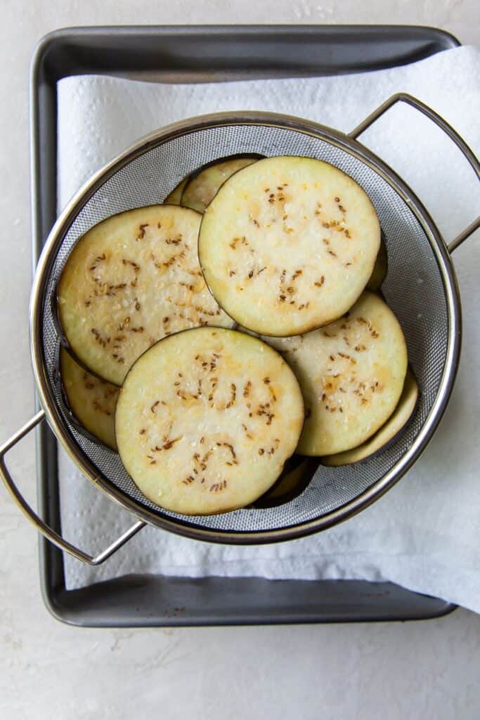 eggplant slices in a colander.