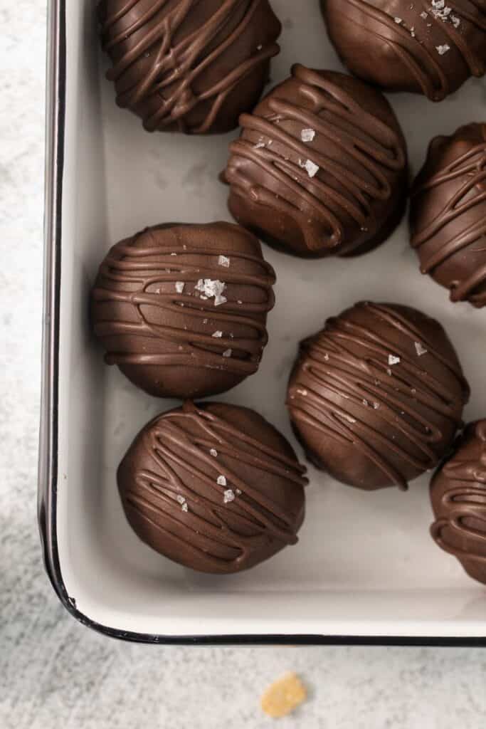 Peanut butter balls with rice krispies close up in a container.