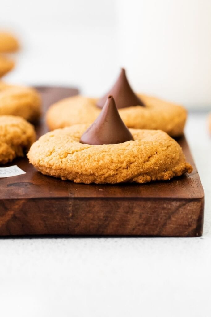 Side view of the 3-ingredient peanut butter blossoms so you can see the thickness and the Hershey kiss on top.