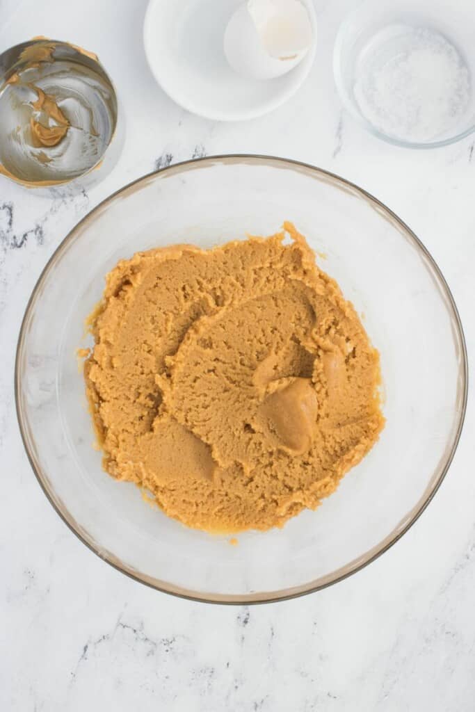 Peanut Butter Cookie batter in a clear mixing bowl.