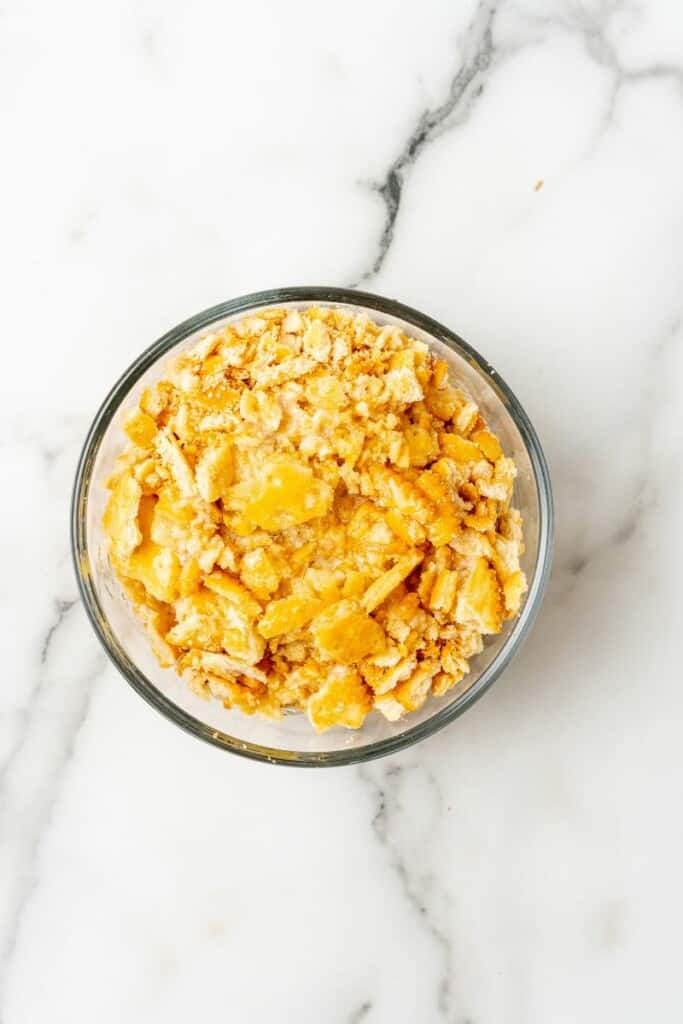 Combining crushed ritz crackers and butter in a small bowl.