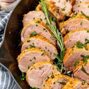 Slices of pork tenderloin prepared in a cast iron skillet.