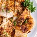 Air fryer flounder fillets on a white plate.