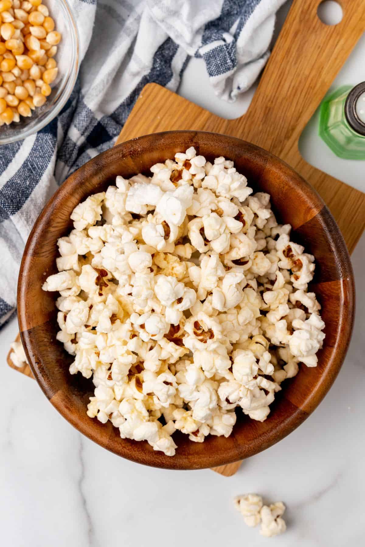 Overhead view of air fryer popcorn in a wooden serving bowl.