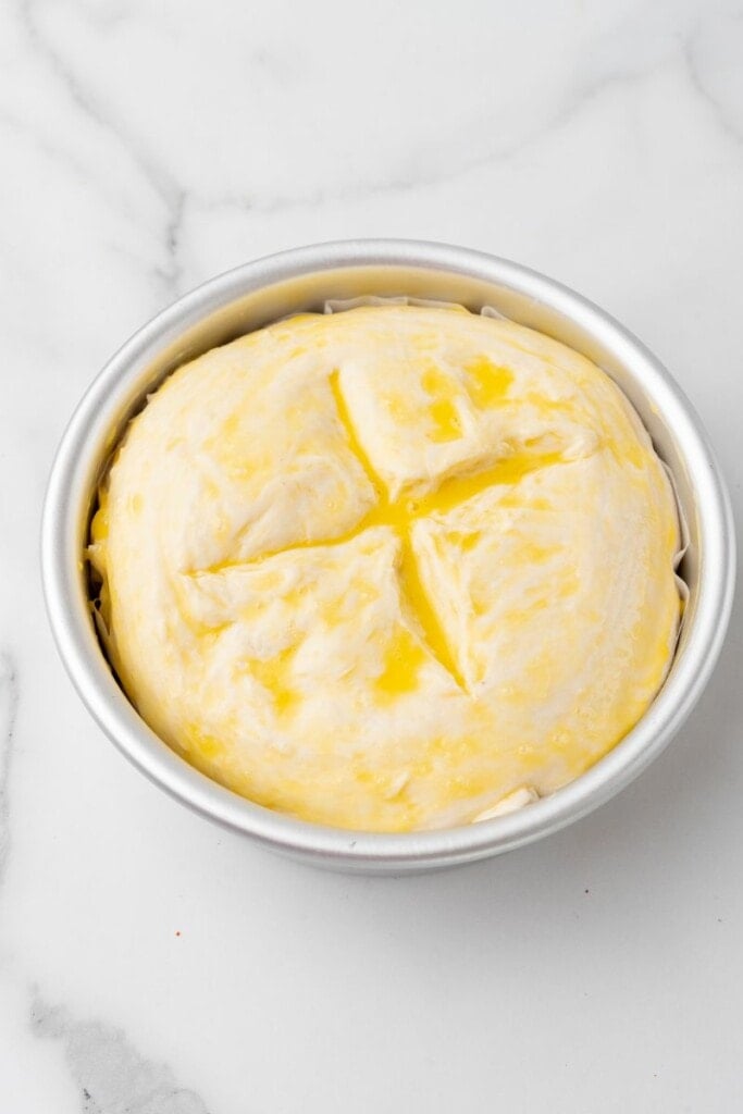 Top of homemade bread brushed with egg before baking.