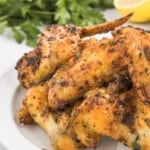 A plate of prepared whole chicken wings.