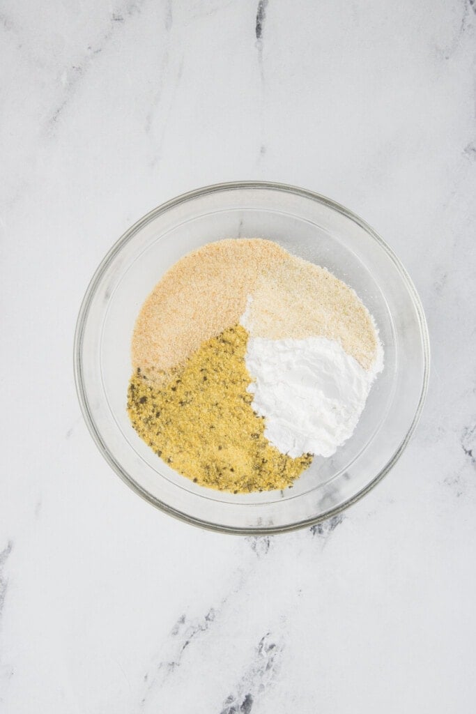 Seasonings for chicken wings in a small clear bowl.