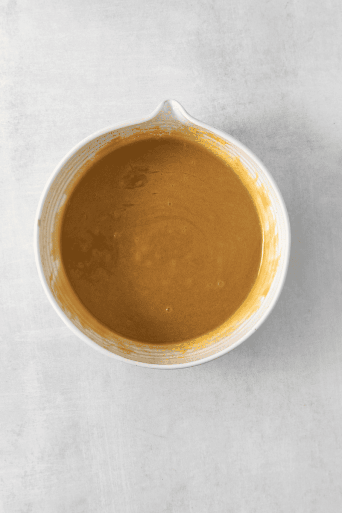 Combining ingredients to form butterscotch in a mixing bowl.