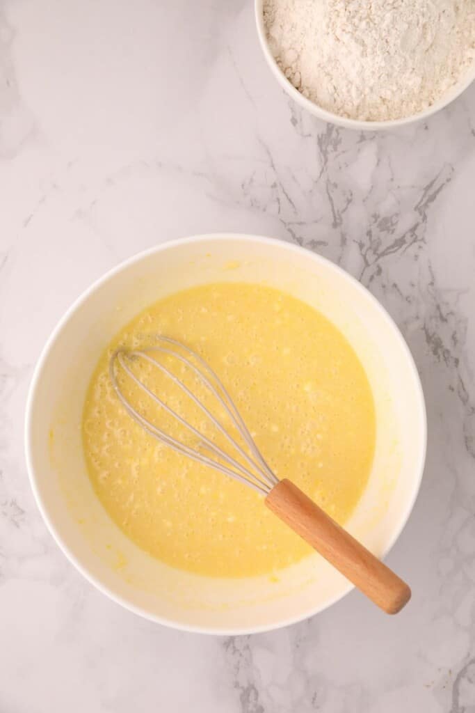 Combining baking soda and milk in a small mixing bowl.