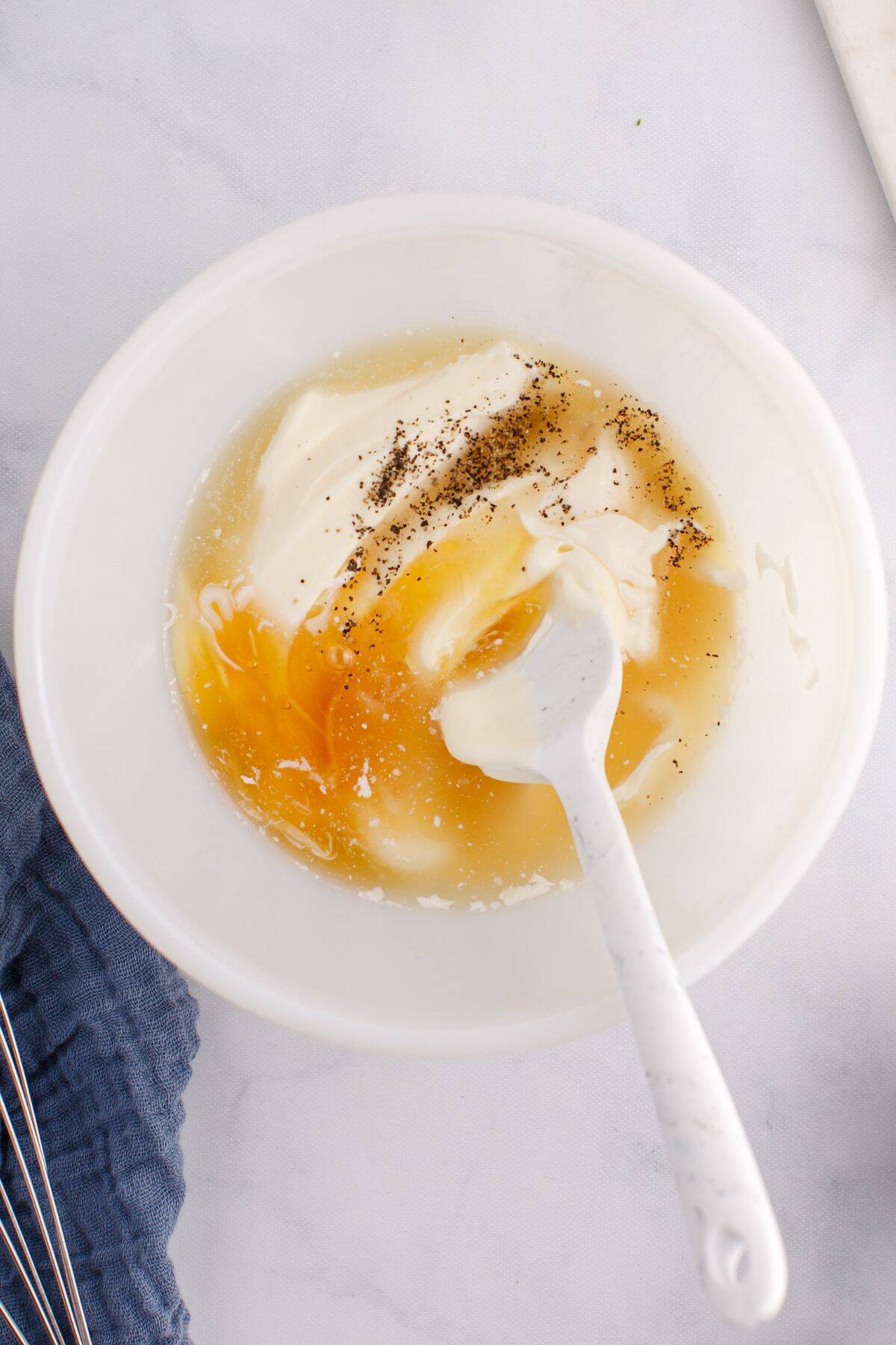 Mixing the creamy dressing in a bowl.