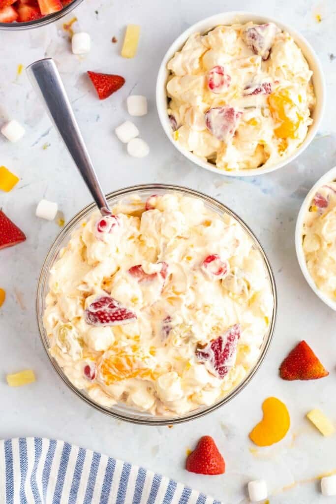 cool whip fruit salad in 3 bowls.