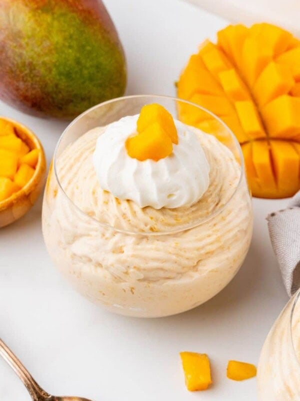A single serving of mango mousse in a dessert dish.