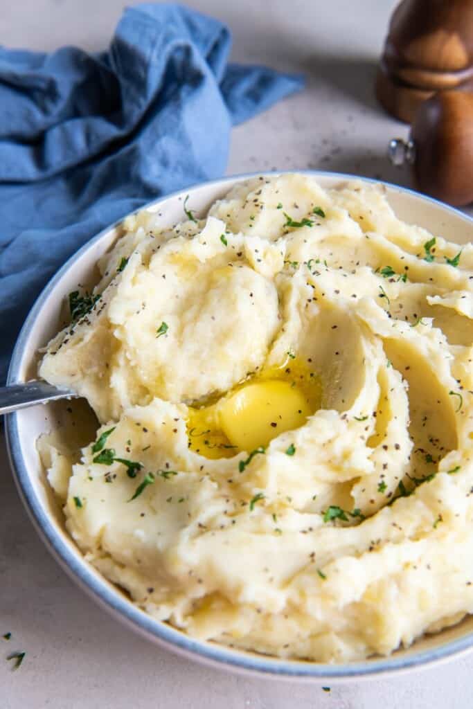 eating a spoonful of dairy-free mashed potatoes.