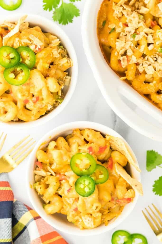 overhead shot of mexican mac and cheese in bowls and casserole dish.