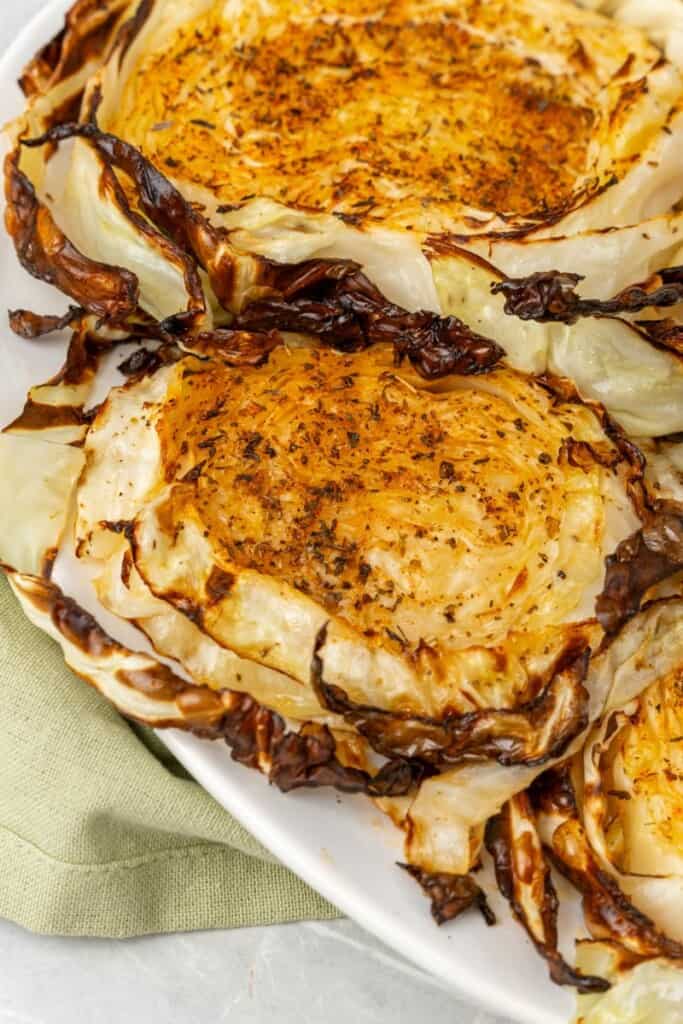air fryer cabbage steaks on a white plate