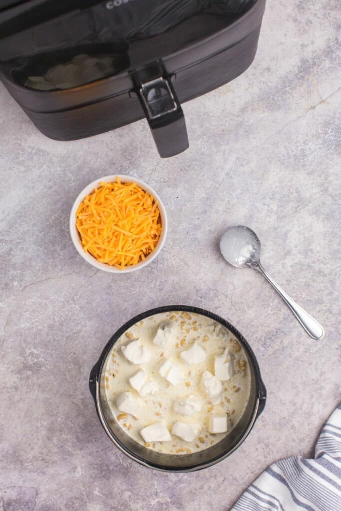 adding in cubed cream cheese to air fryer pot.