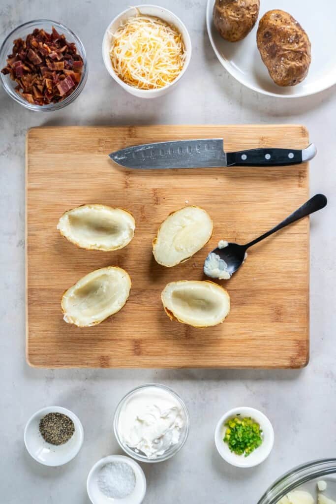 slicing cooked potatoes and scooping out the middle.