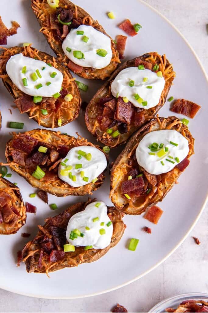air fryer potato skins with bacon, sour cream and green onions.