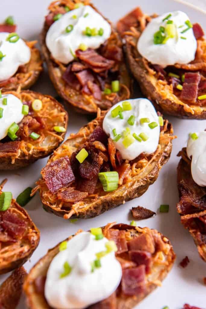 close up of loaded potato skins in air fryer.
