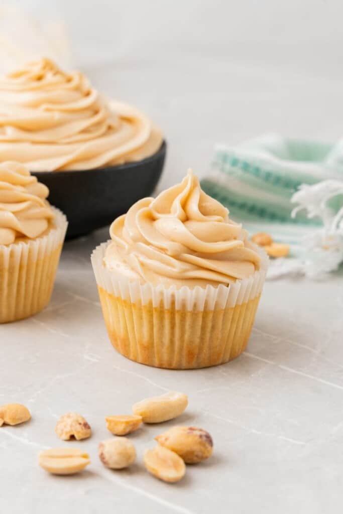 Close up shot of vanilla cake frosted with creamy peanut butter cream cheese icing.