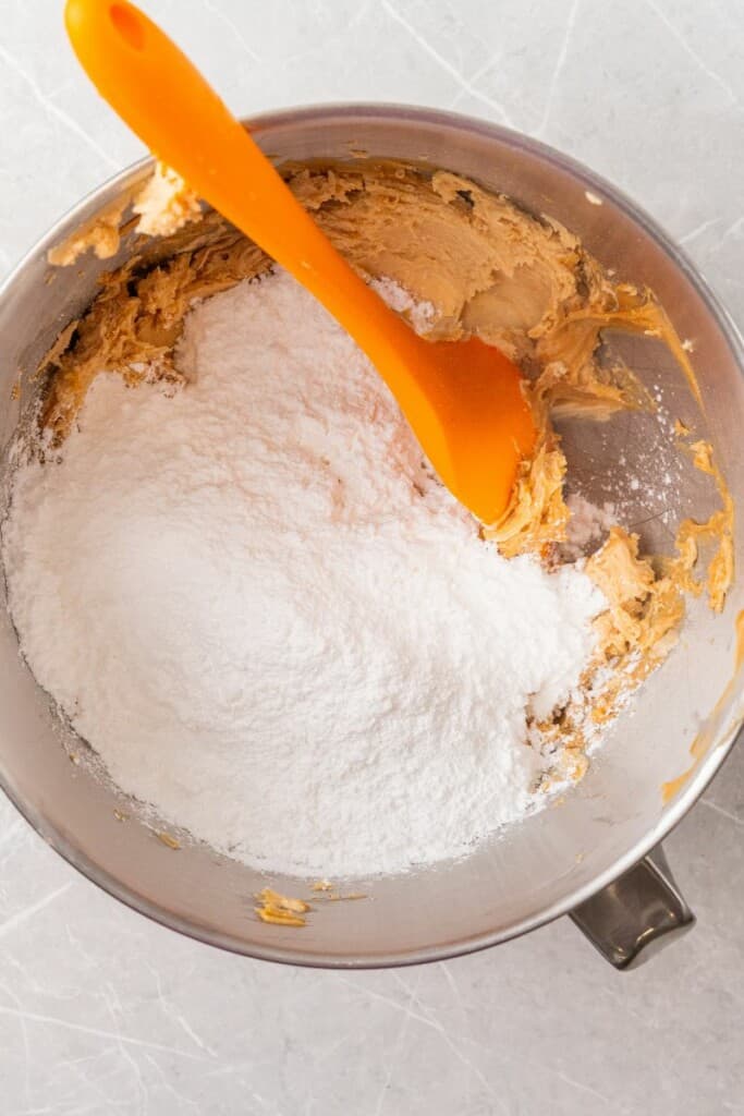 adding powdered sugar to peanut butter mixture.
