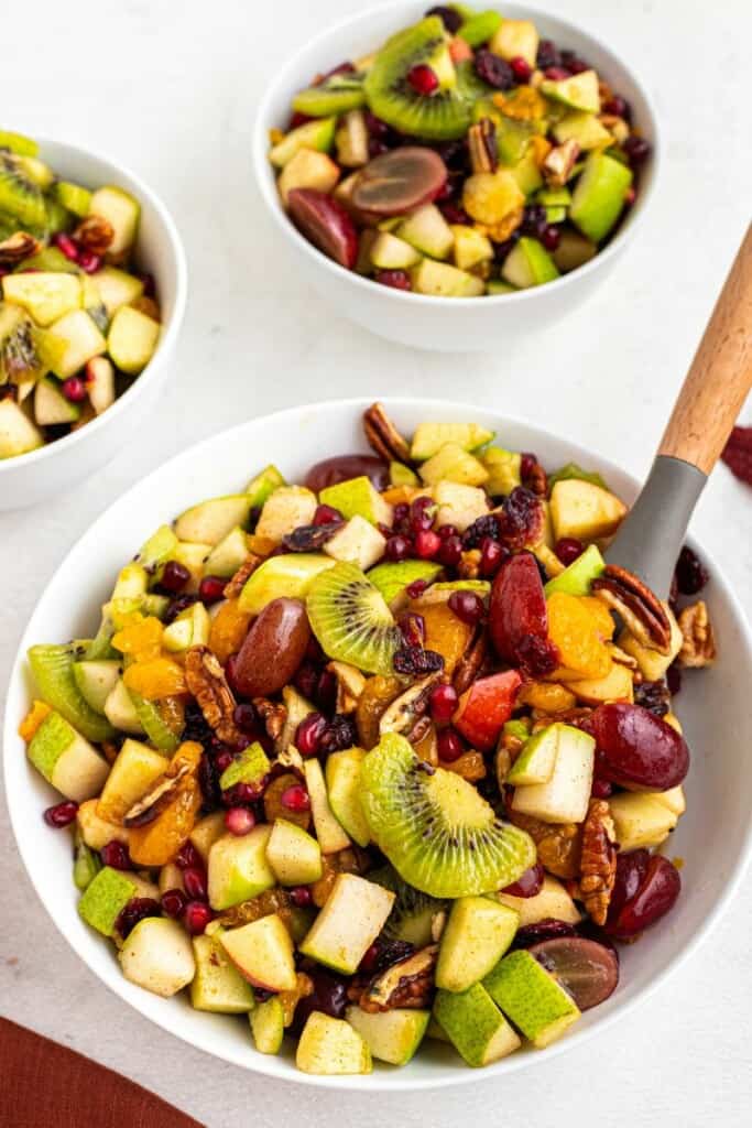 fruit dishes for Thanksgiving in a white bowl with a spoon.