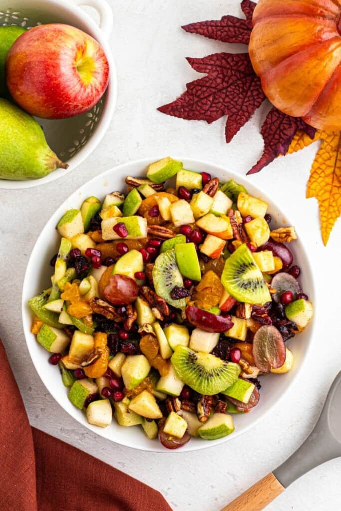 tossing fruit salad with homemade dressing.