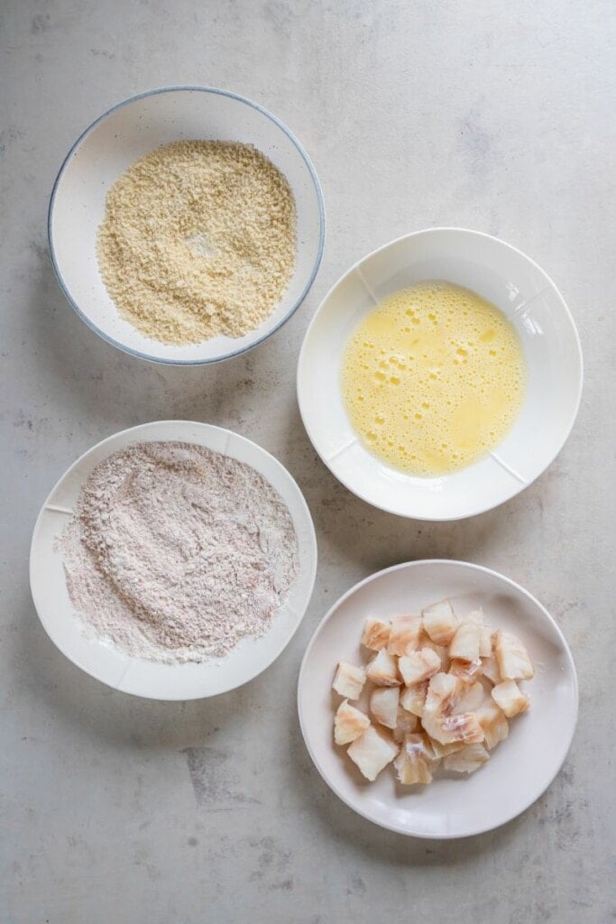 mixing spices in flour and beating eggs.