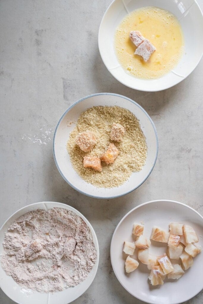 adding fish pieces in egg wash and breading.
