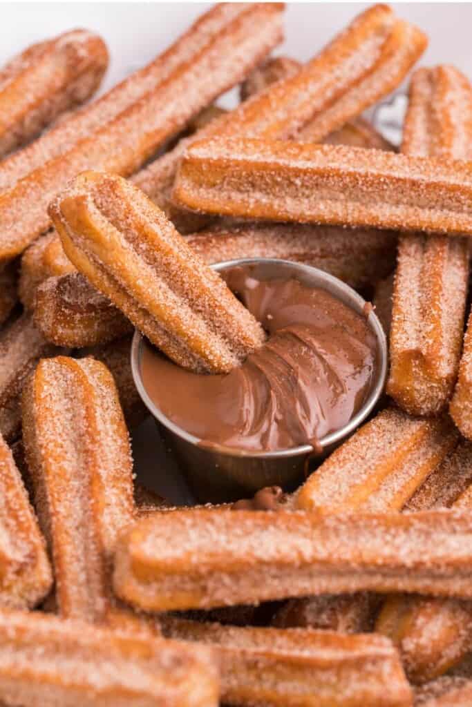 dipping air fryer churro into chocolate dip