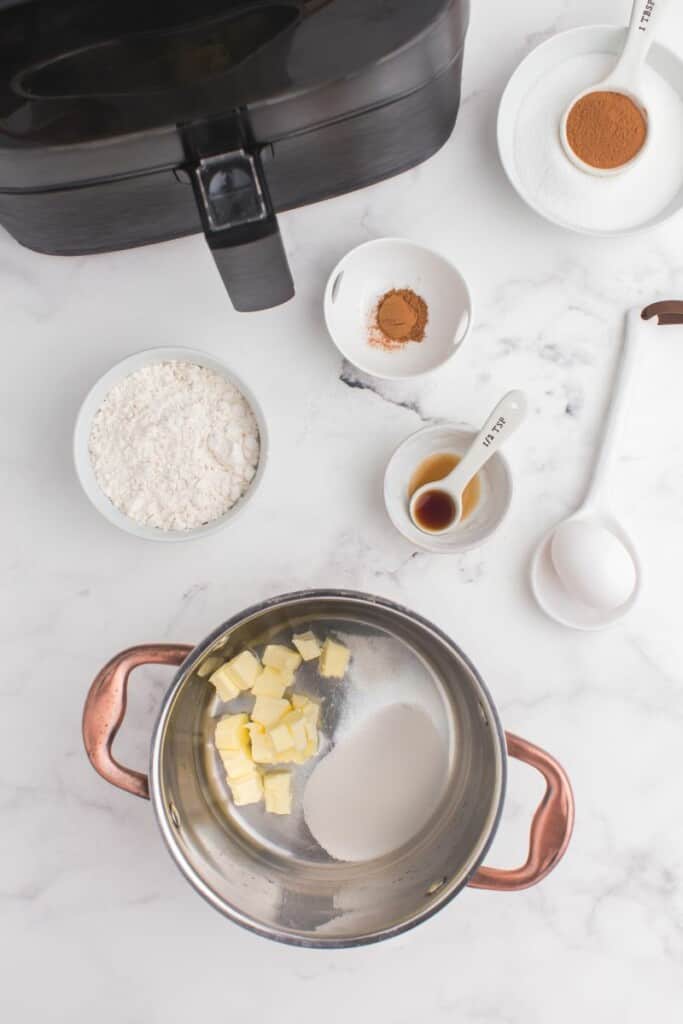 adding butter and sugar to pot