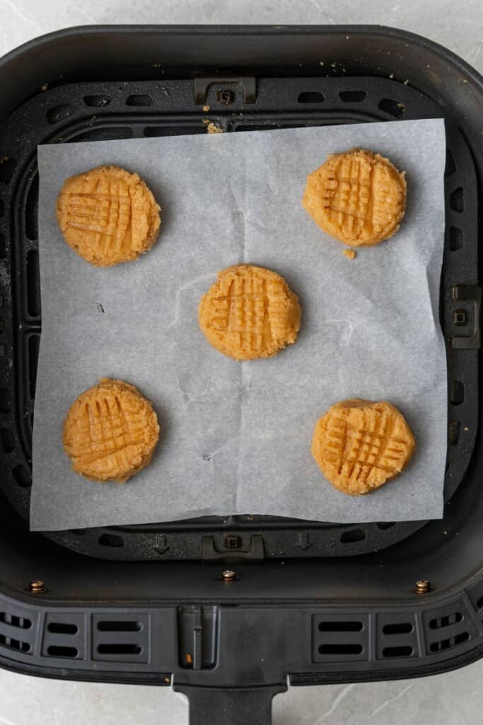 adding peanut butter cookie dough to air fryer basket