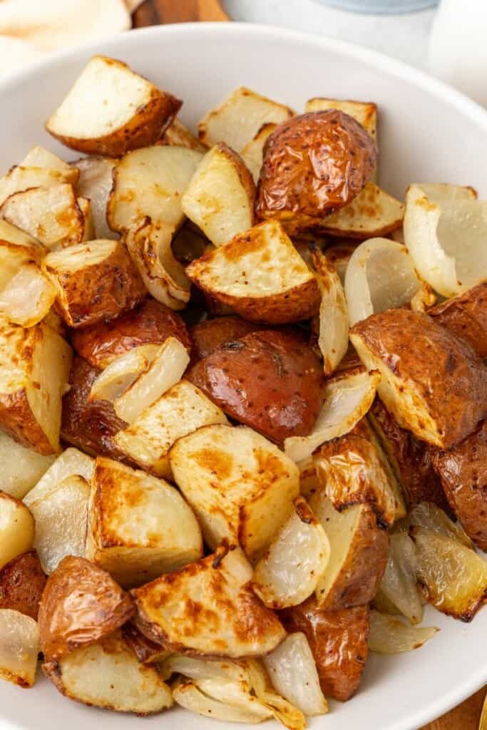 close up of red potatoes and white onions in a bowl