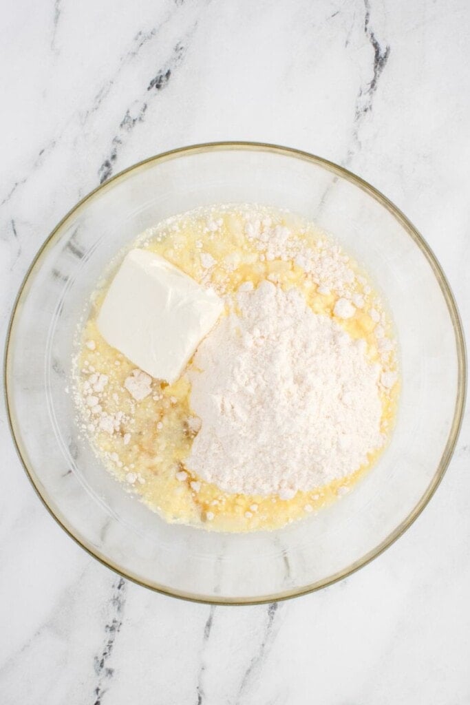 a bowl filled with cream cheese and cake mix