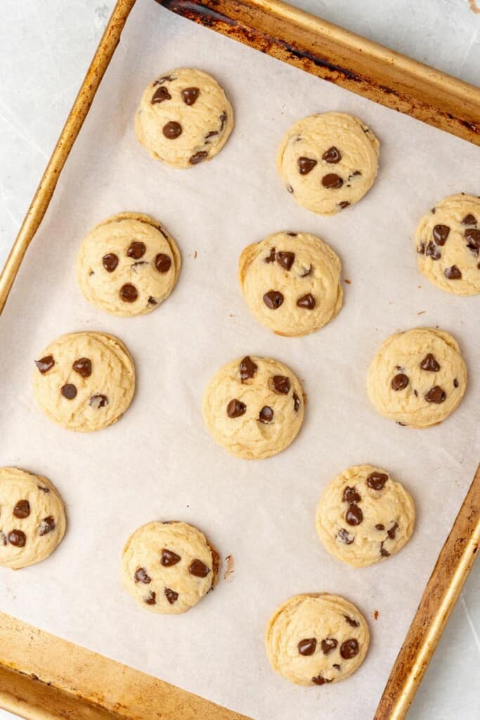 baked eggless chocolate chip cookies on a baking sheet