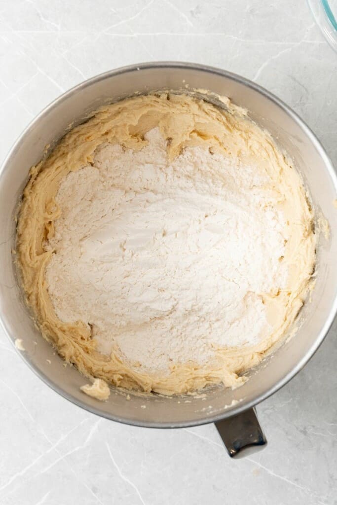 adding flour to creamed butter and sugar