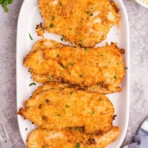 cooked air fryer parmesan chicken on a white platter