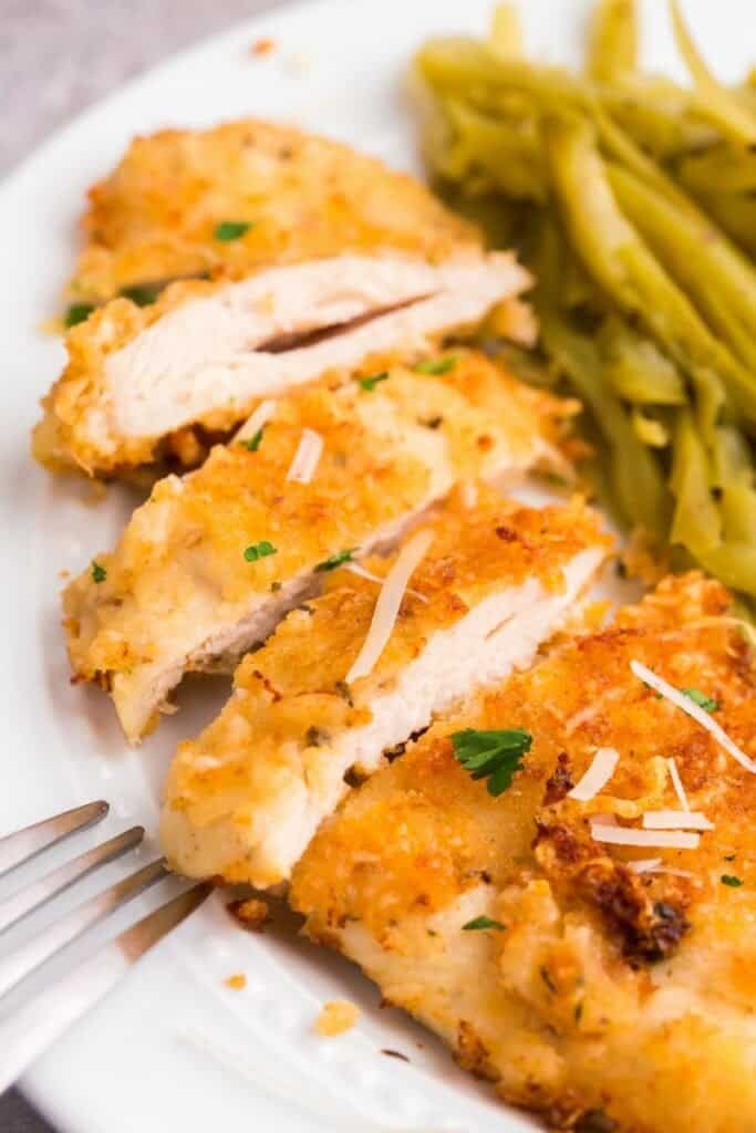 close up of sliced parmesan chicken in the air fryer