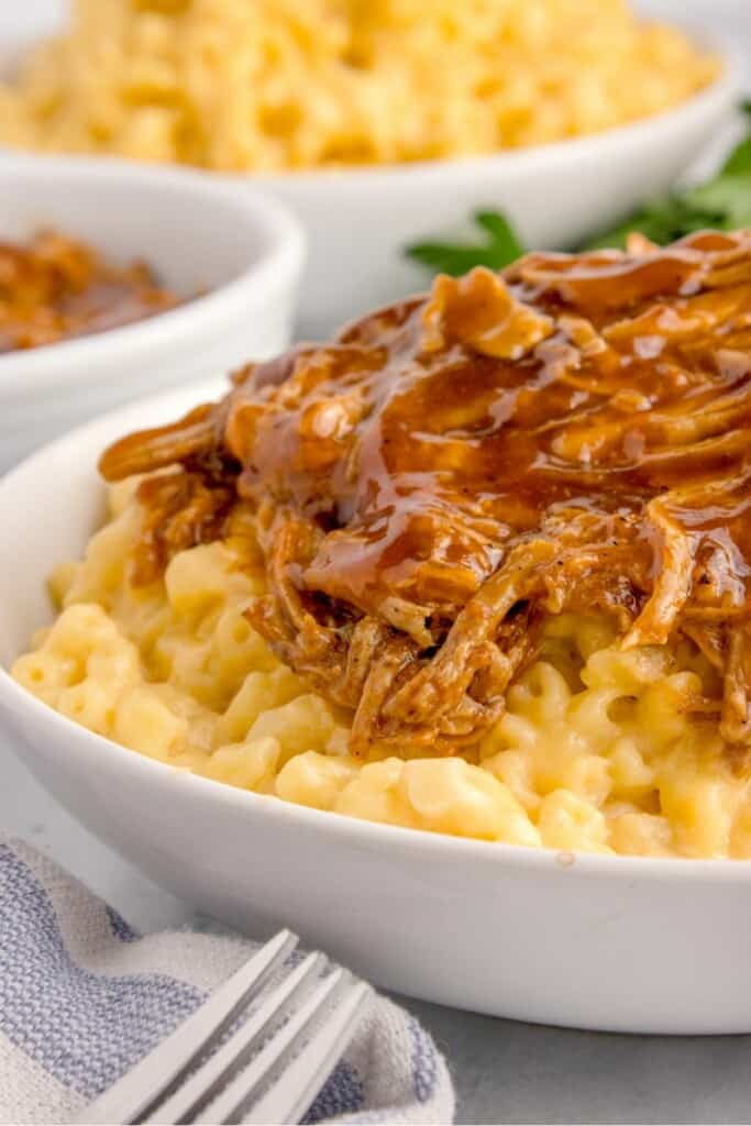 bbq pull pork mac and cheese in a white bowl