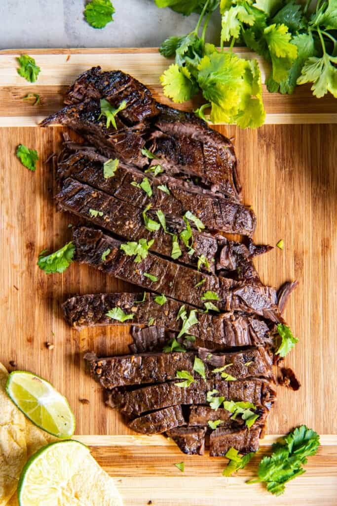 overhead shot of marinated flank steak cooked in the slow cooker on low