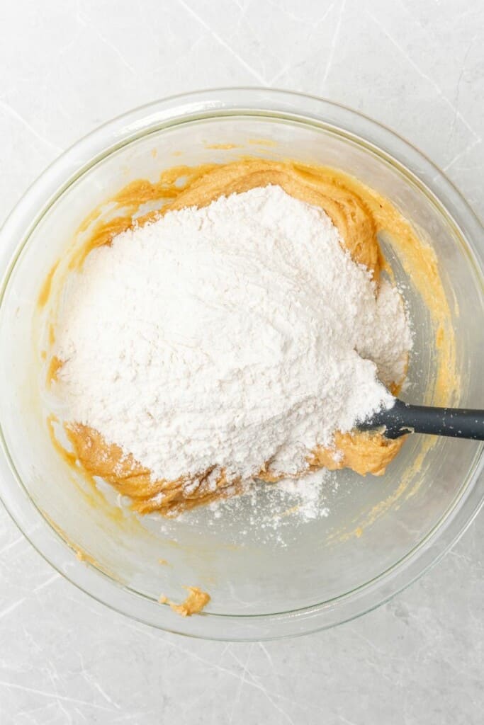 mixing together flour mixture with peanut butter mixture