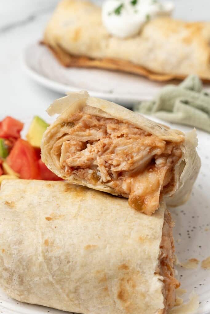 Shredded chicken mixture inside golden fried tortillas.
