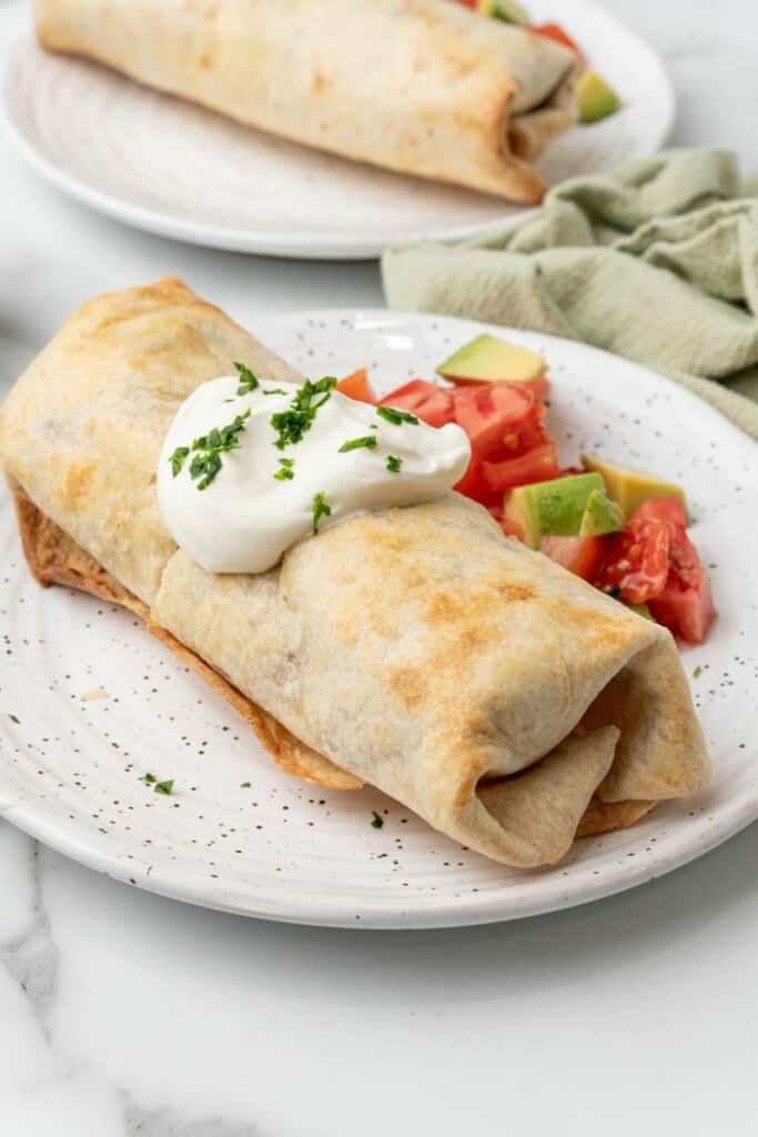 Mexican air fryer chimichangas served on a plate.