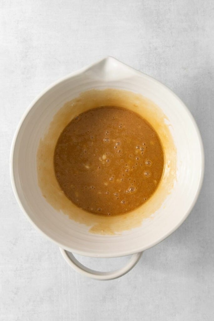 Wet ingredients mixed in a large white bowl.