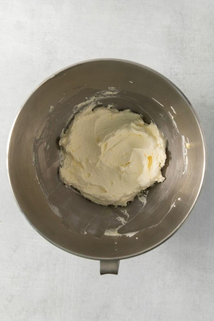 Whipped pudding topping in a mixer bowl.
